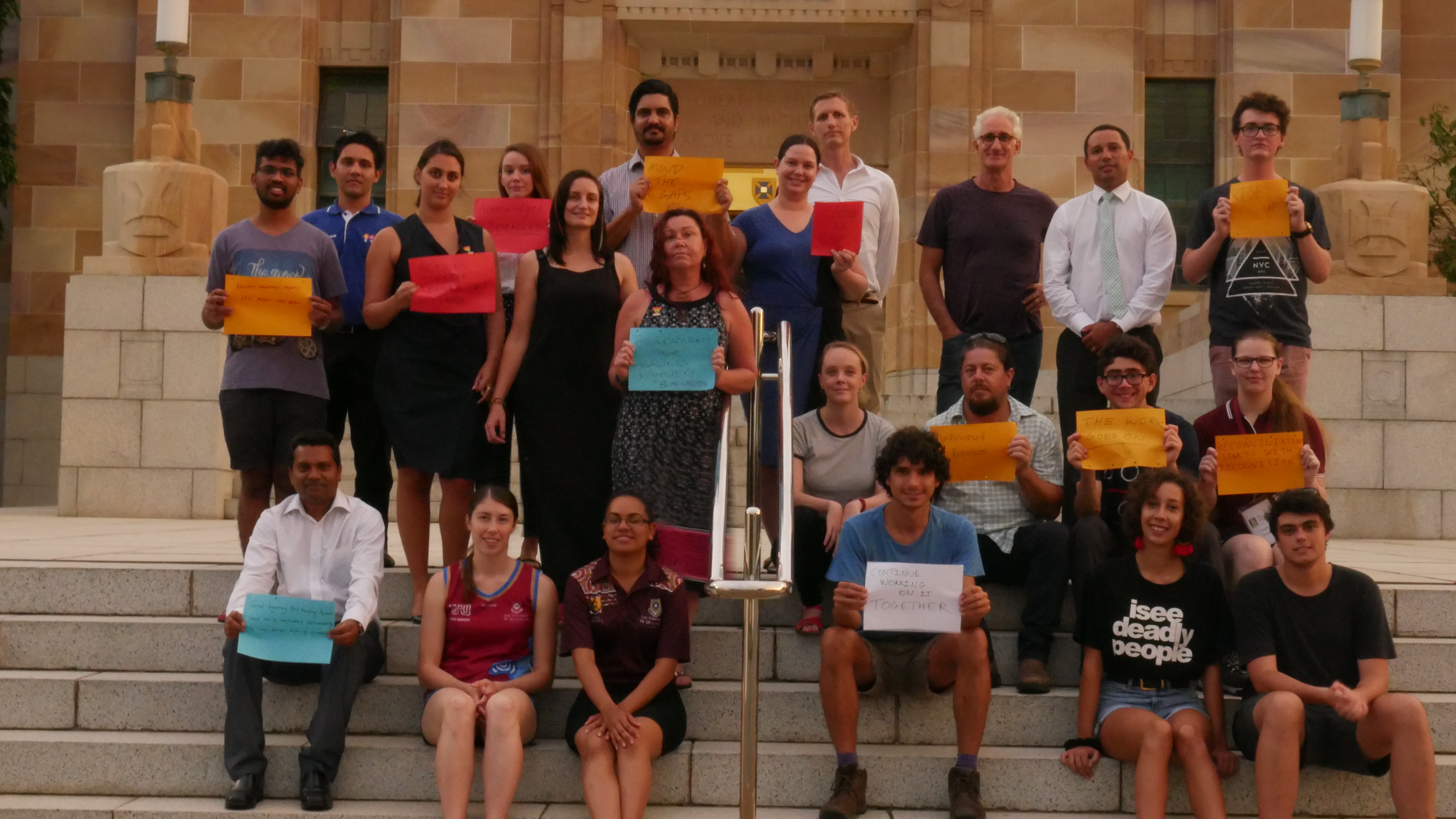 UQ staff and students gather on the steps of Forgan Smith