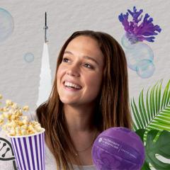 A young adult woman surrounded by graphic illustrations of two large leaves, a DNA strand, a bucket of popcorn, a netball, coral, bubbles, and a rocket
